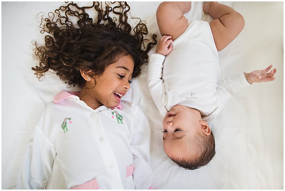 Beautiful sibling love during a bedtime story with the boucher family by lifestyle photographer audrey blake breheney
