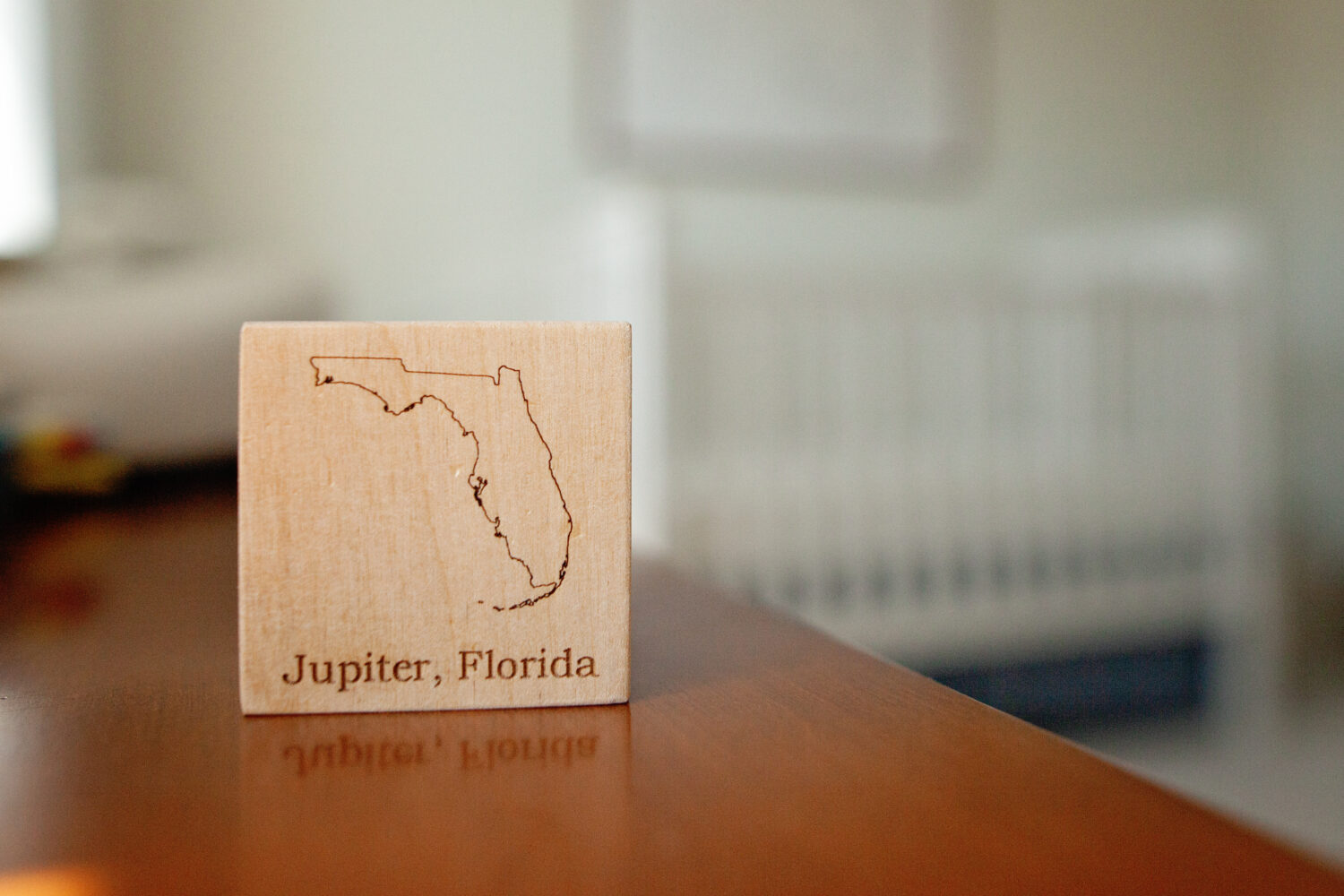 a small wooden block with Jupiter, FL written on it.