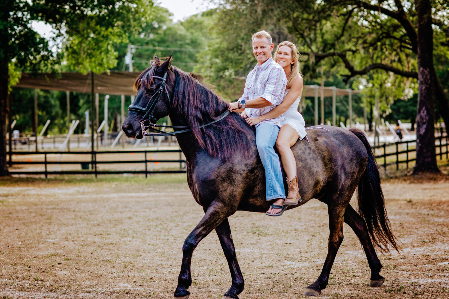 Couple on a horse riding and laughing
