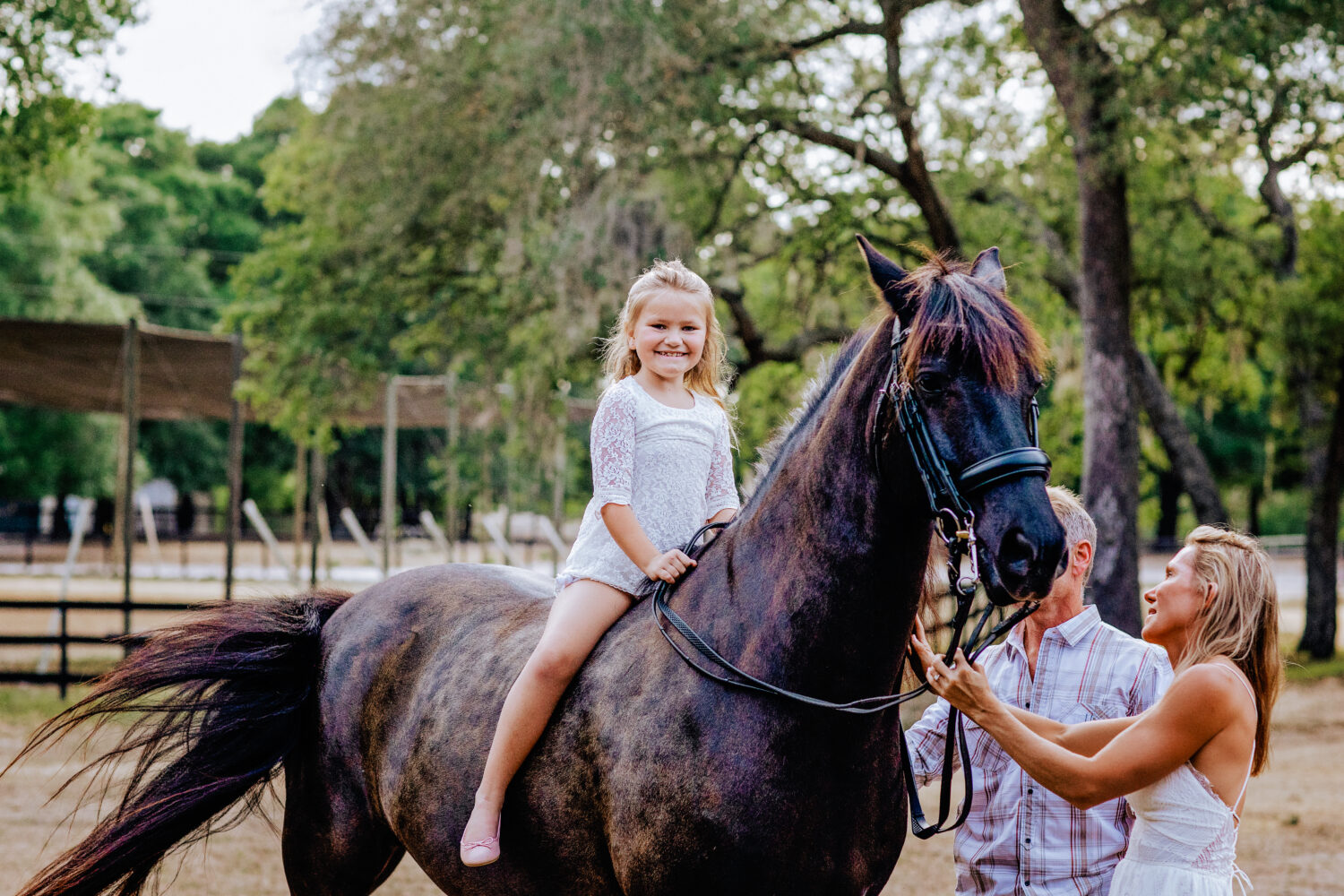 beaming little girl on a horse