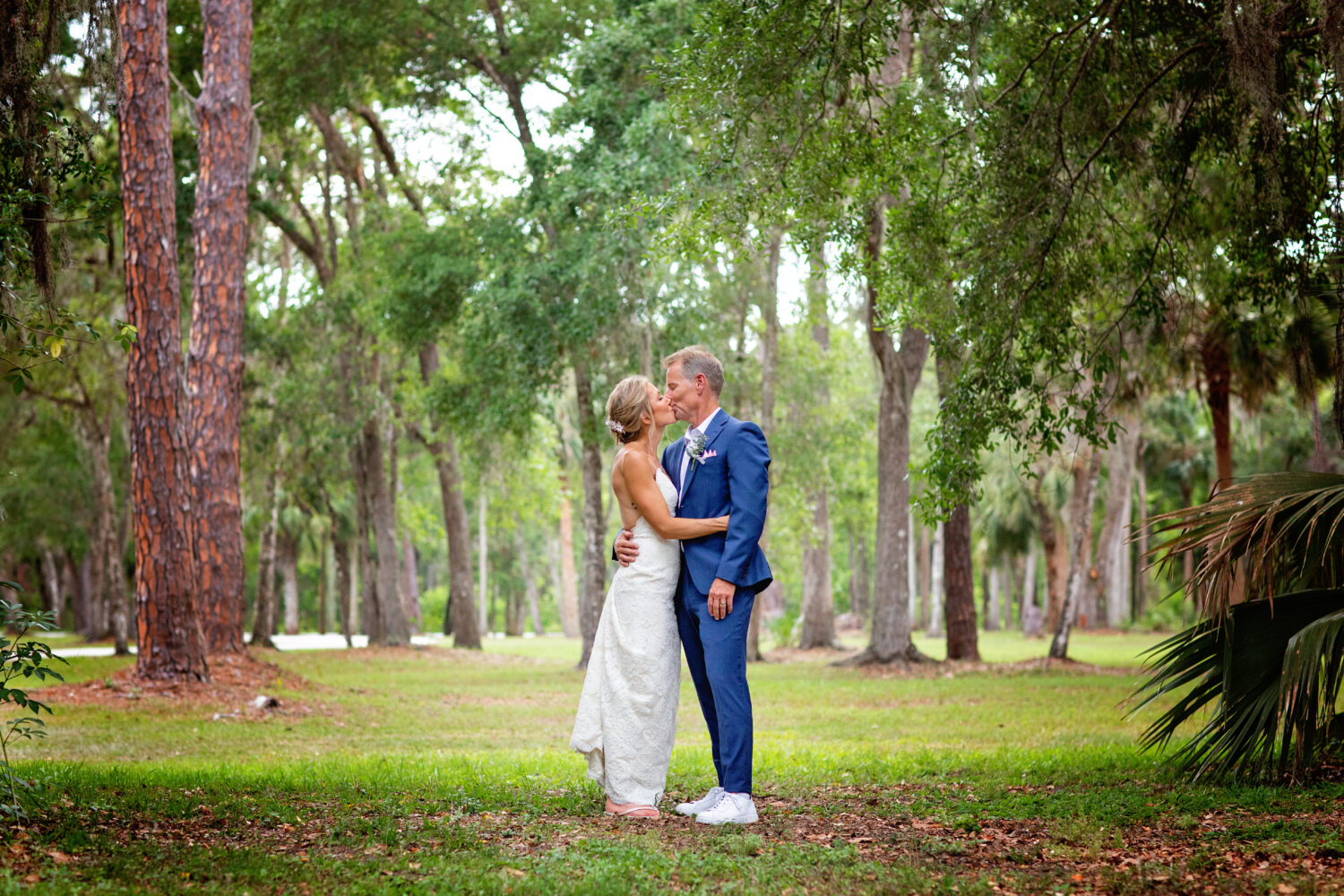 bride and groom kissing in the trees