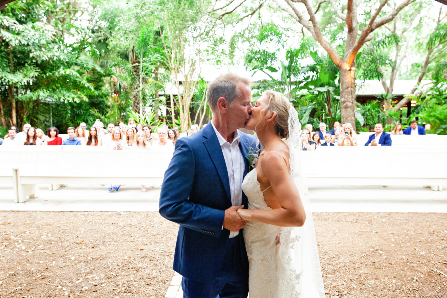 bride and groom on their first kiss
