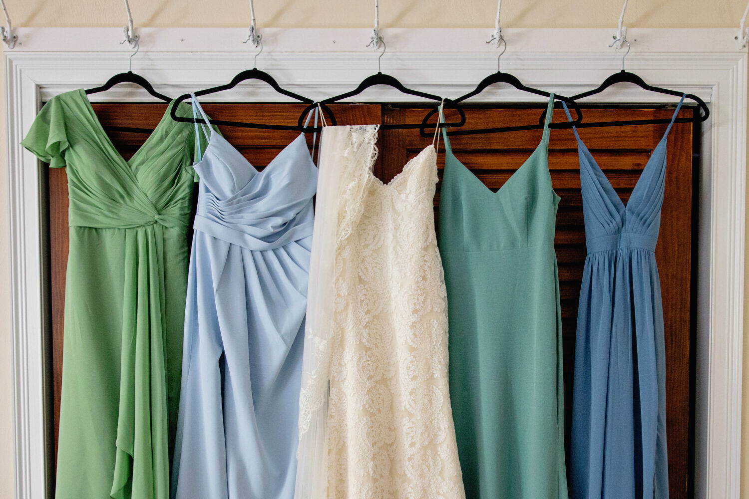 the dresses in a row on black hangers