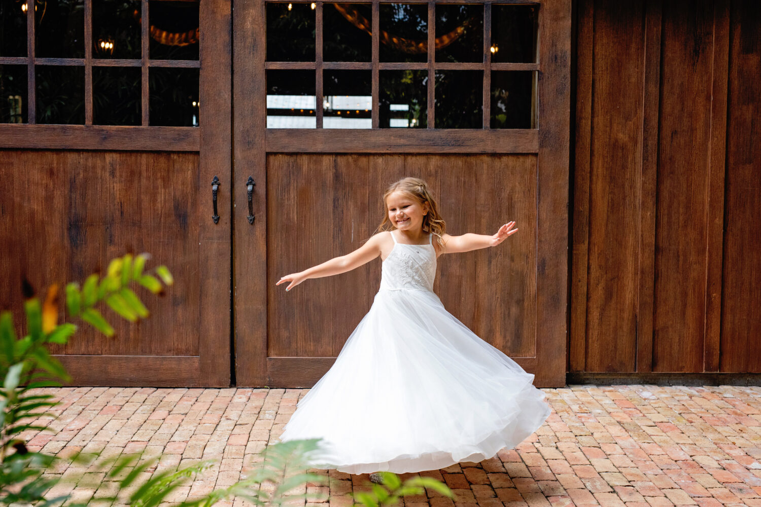dancing little girl in a flower girl dress